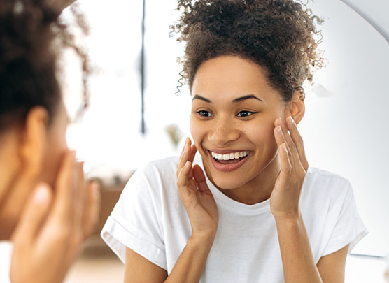 Woman examining her smile in a mirror